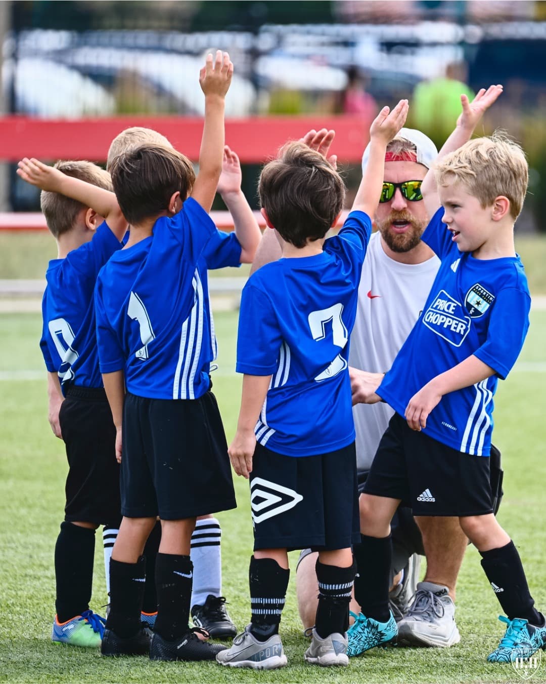 An SBV Rec team and its coach high-five at SBV HQ
